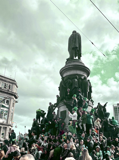 People perched on the statue for a better view of the parade